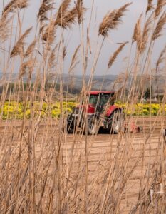 BUSY at Work Agibusinees tractor in feild