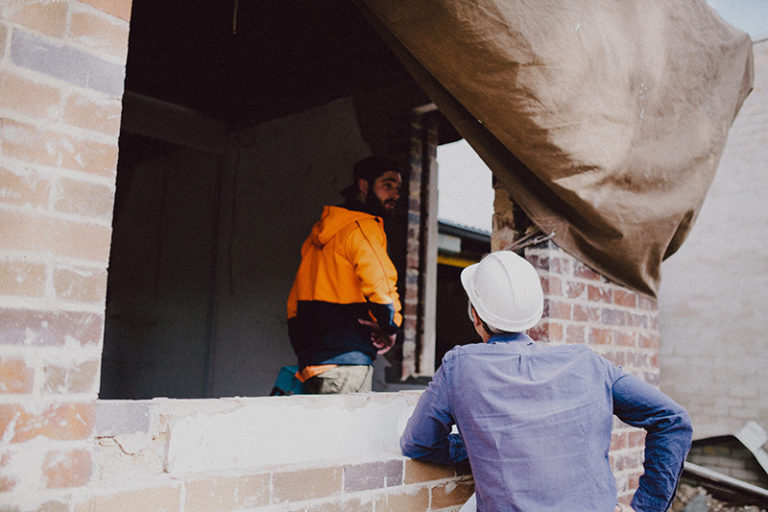 apprentices and worker on site