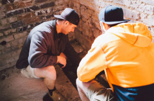 Two tradesmen crouching