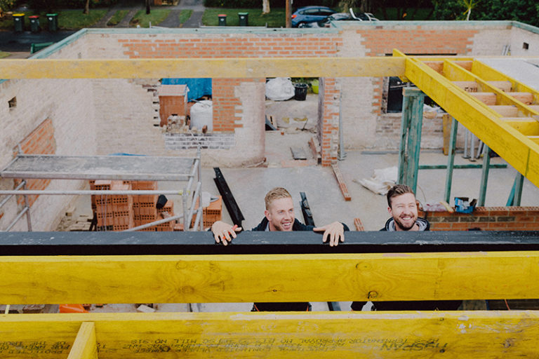 2 men smiling on the worksite