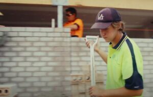 Young male in PPE gear on worksite.