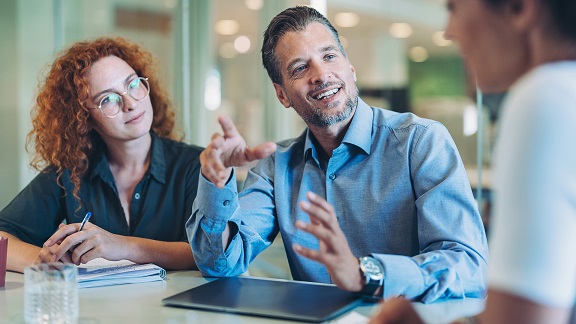 Woman and man in a work training session with trainer